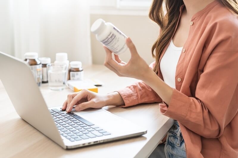 woman checking medication warning through searching on internet