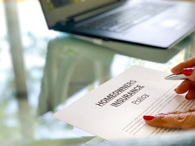 man reading homeowners policy documents