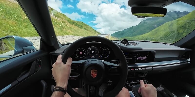 man feeling luxury feel while driving porsche car 