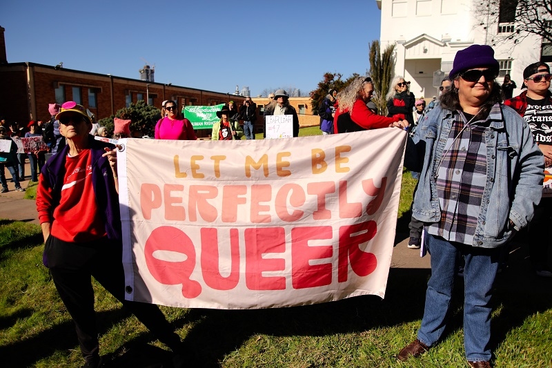 Two activists protest for LGBTQ rights at a rally preceding the Women's March 