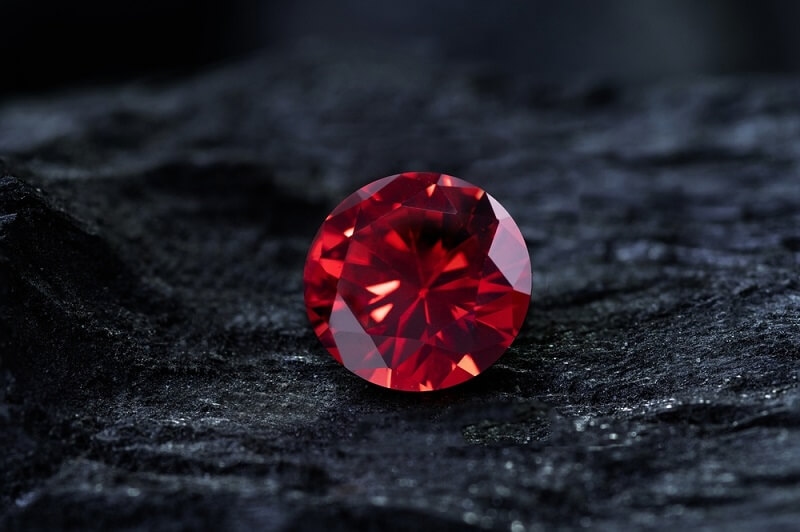 sapphire stone on black coal background