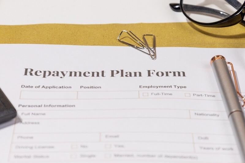 repayment plan form in file with pen on it