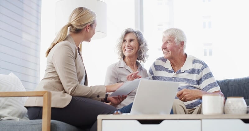 women agent explaining best annuity option to couple for retirement