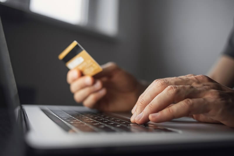woman using cards in off season sale