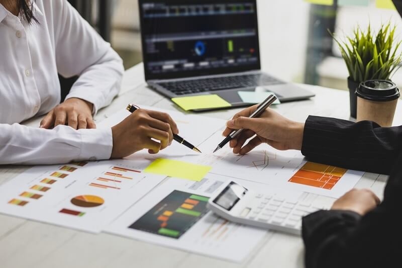 two working women checking risk checklist