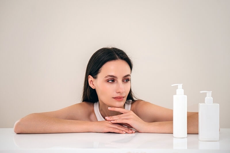 woman looking at shampoo bottles