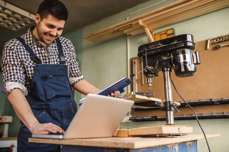 man working on smart equipment in his work