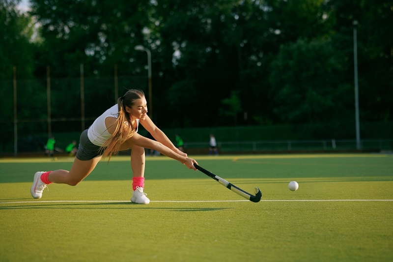 girl hockey player plays field hockey 