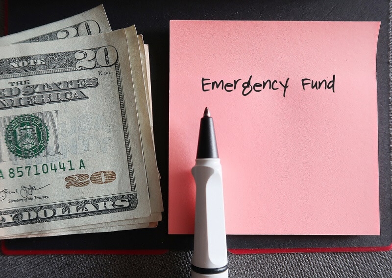 man putting money with emergency fund bar