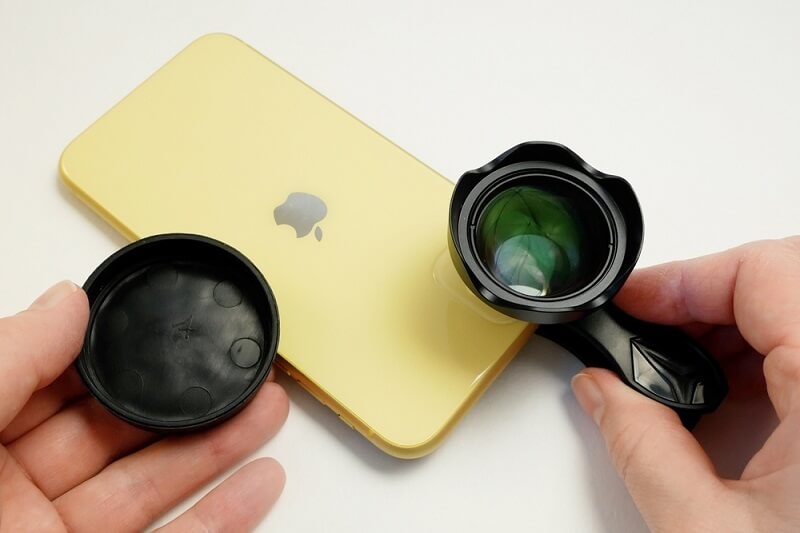 man attaching lenses on smartphone