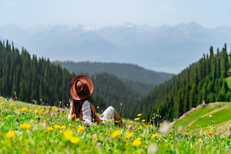 Young woman traveler relaxing and enjoying beautiful Scenery landscape with colorful flowers 