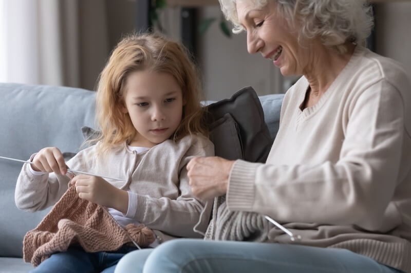 little girl helping her grandmother