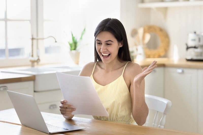 woman smiling and feeling happy after student loan approves