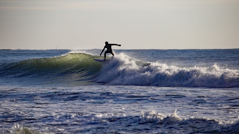 man surfing in high tides in ocean