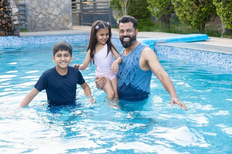 indian family in swimming pool