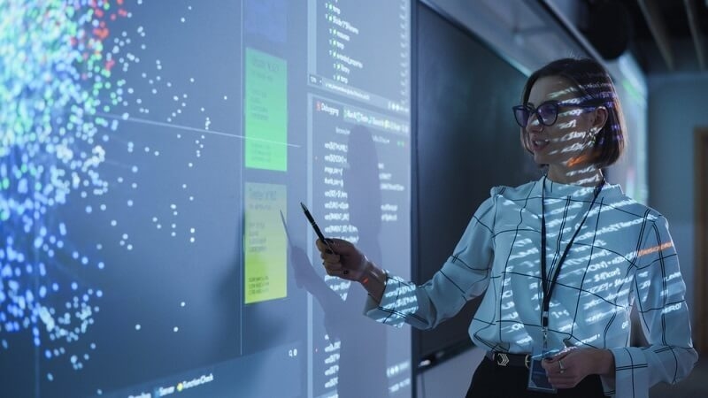 woman teaching students with help of AI technology