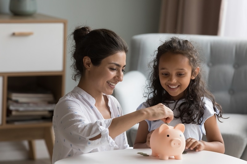 women Teaching her Kid a Money skill