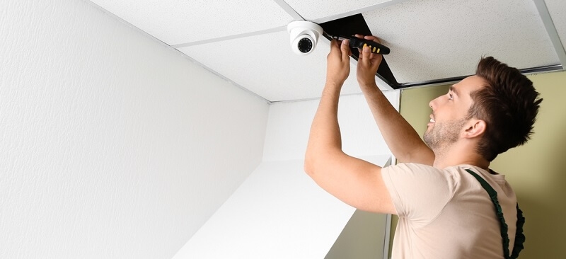 technician installing motion detector camera