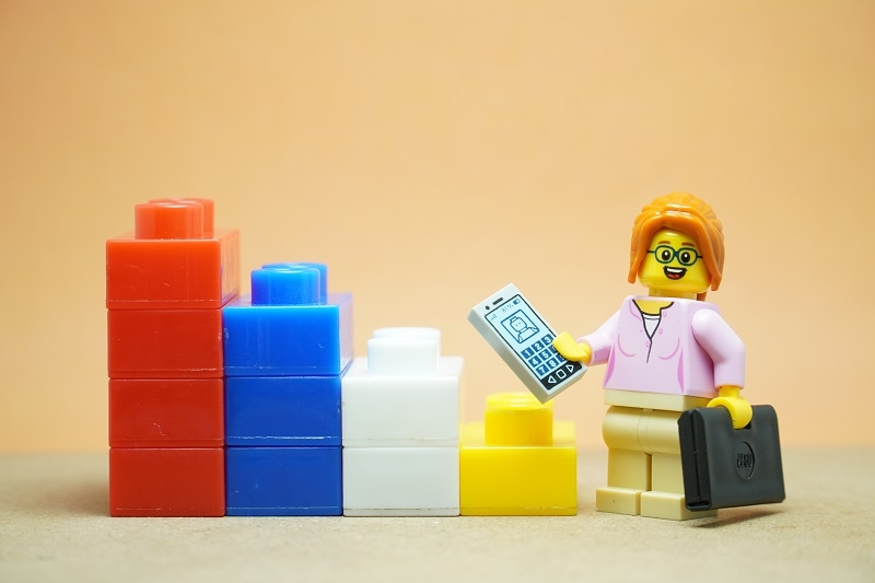 Mini toy of action figure at office with blurred background. Toy photography concept design.