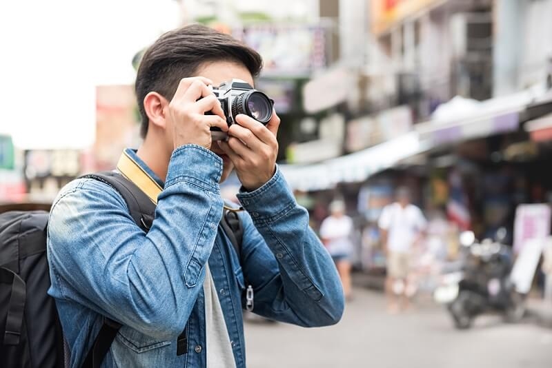 young asian tourists clicks picture of random things