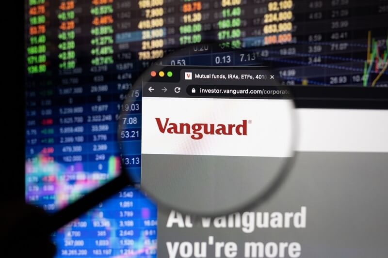 vanguard website view with stock exchange in background