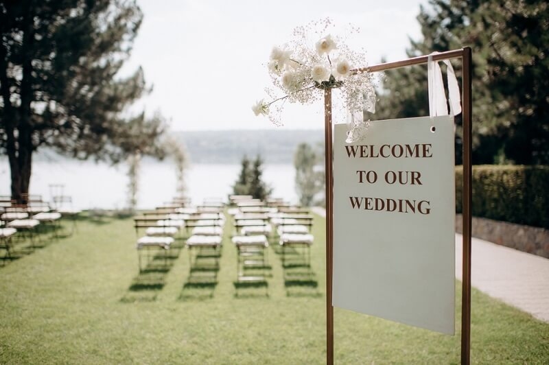 wedding welcoming board in backyard with all decorations