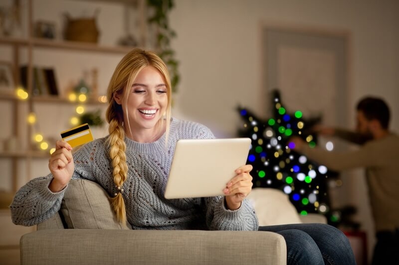 woman seems happy after using holiday coupons in shopping