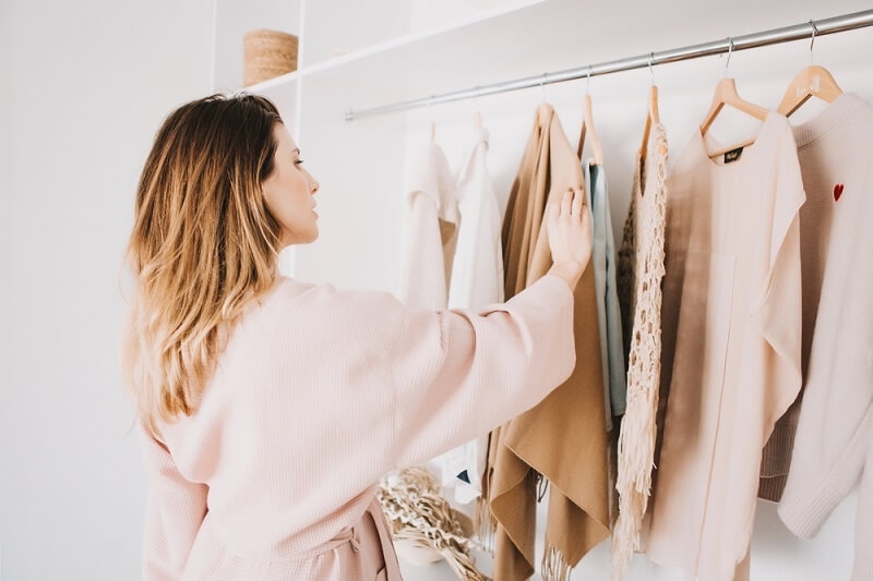 woman selecting clothes from wardrobe