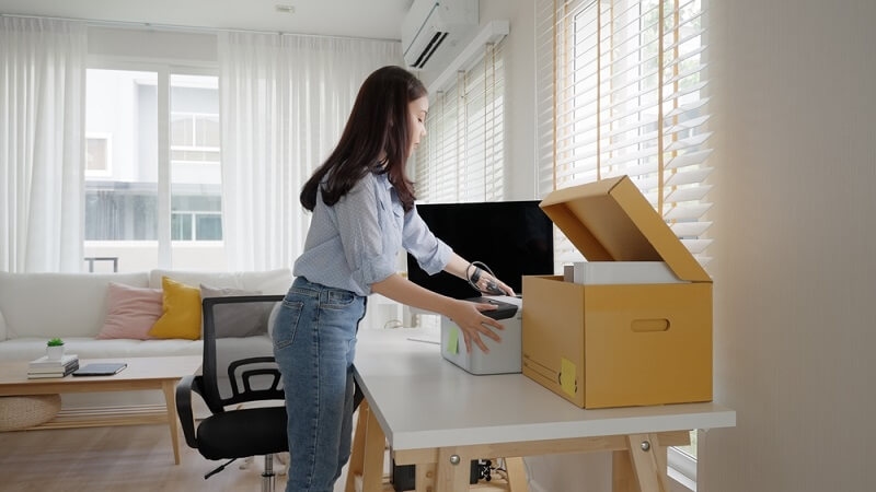 woman arranging personal items on table