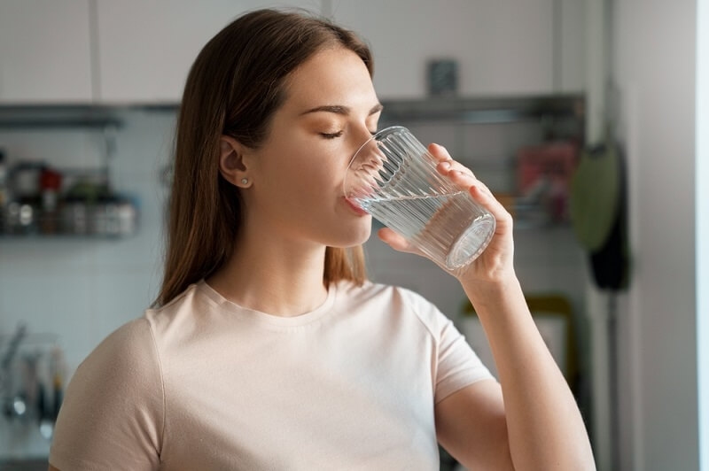 woman drinking water in morning