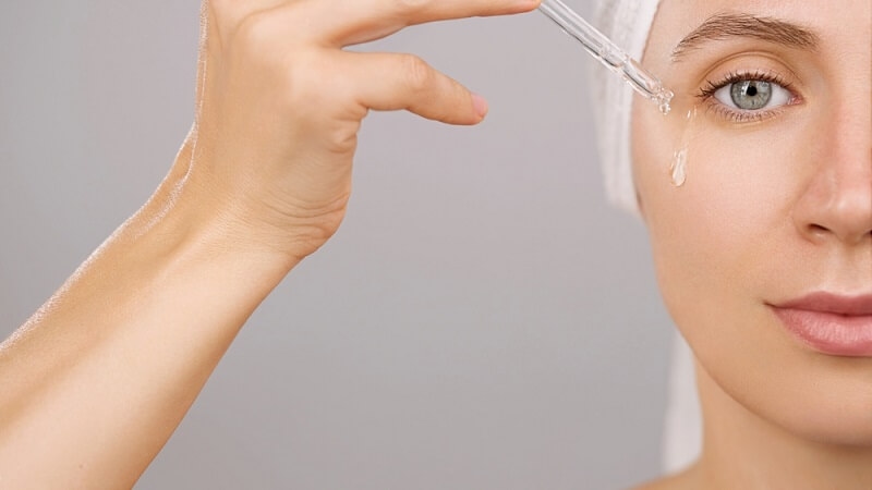 woman uses face serum 