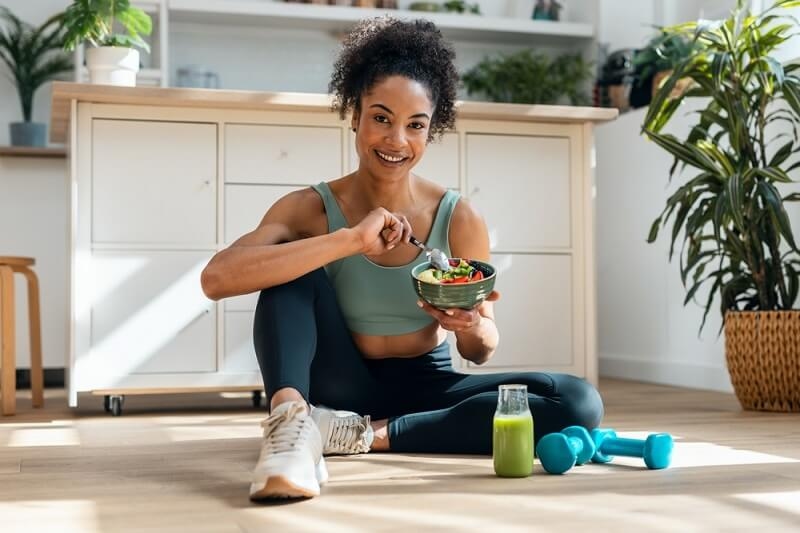 woman eating healthy food after gym