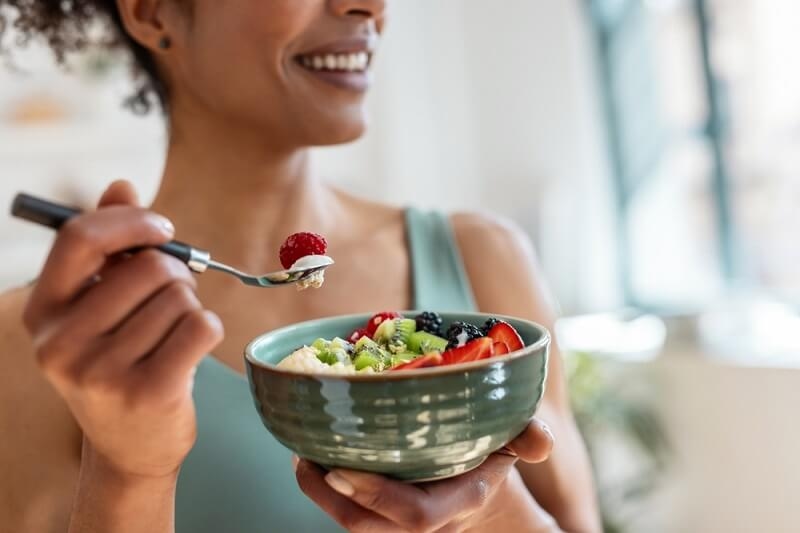 woman eating healthy food in breakfast