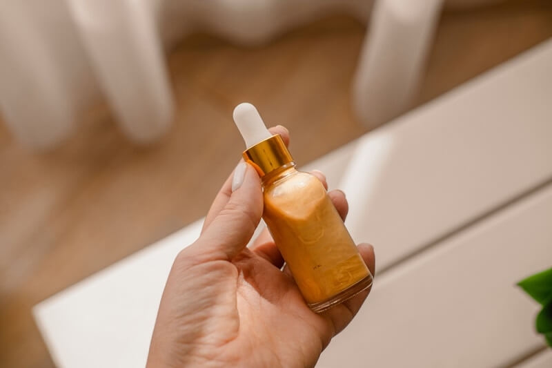 woman holding liquid highlighter