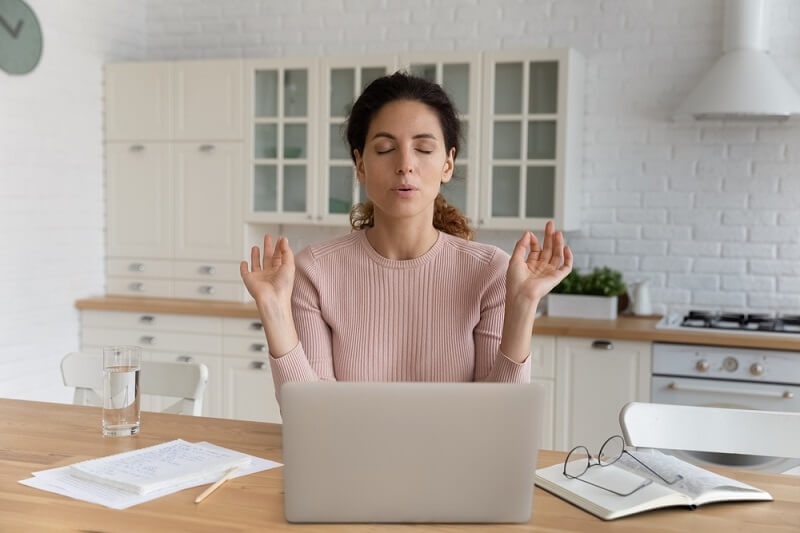 woman doing meditation in between work