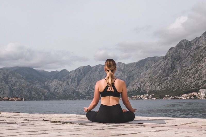 woman doing yoga in mountains