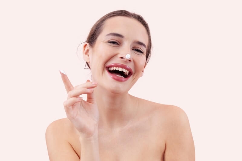 woman doing morning skincare routine