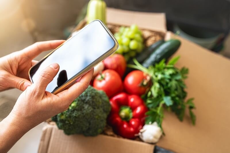 woman ordering online through Q-commerce