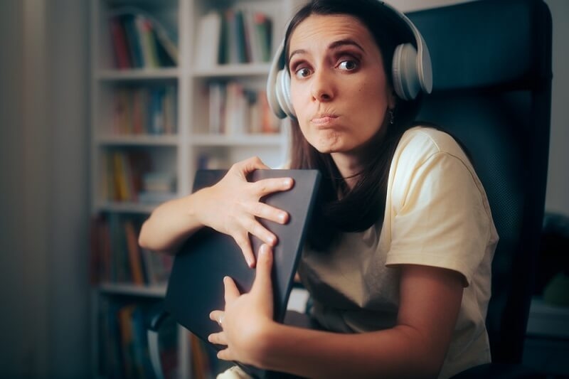 woman hiding her laptop from scam policy holders