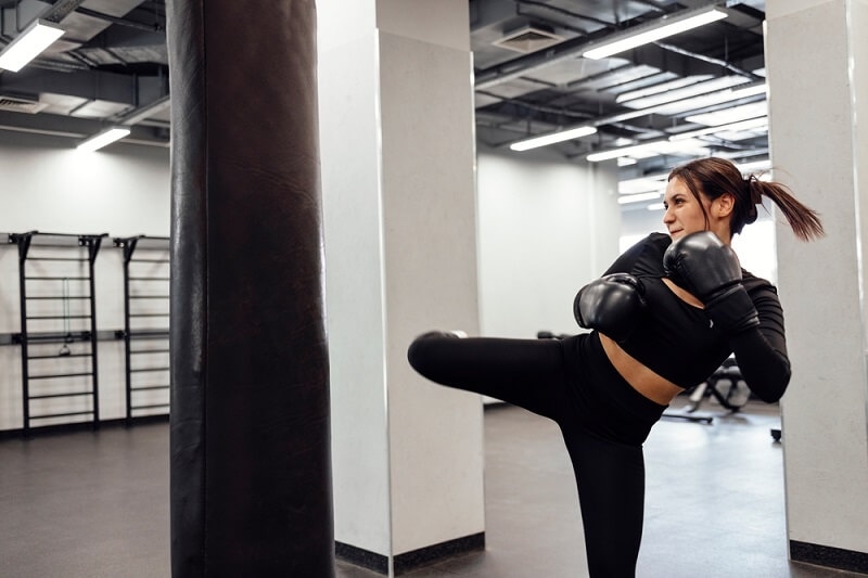 woman practicing in sauna suit 