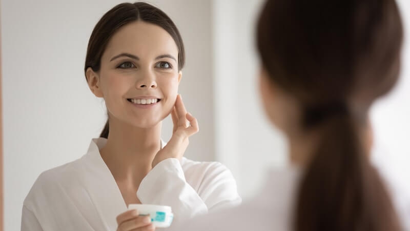 woman feeling happy after result of sensitive skin moisturizer on her face