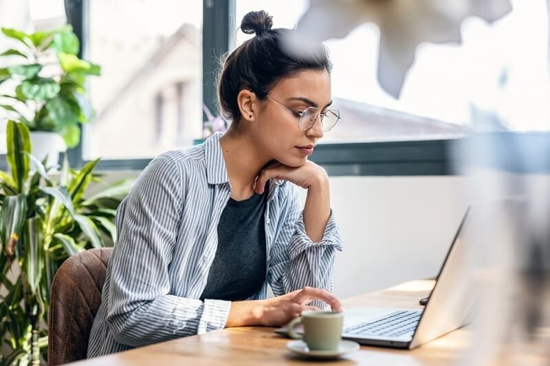 beautiful woman sitting and working positively to achieve productivity