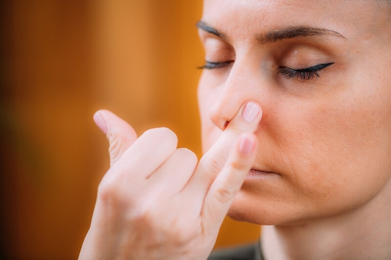 woman doing nostril exercise for improving breathing