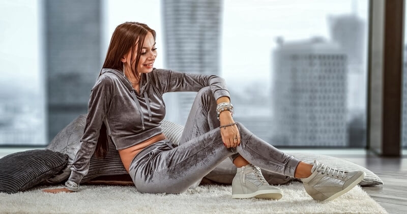 girl sitting on couch wearing loungewear