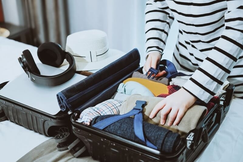 woman packing up her stuff with accessories