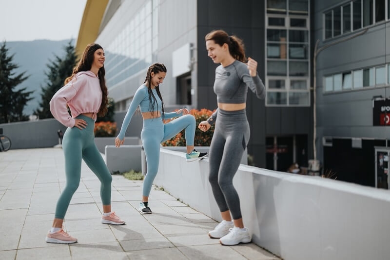 three girls wearing athleisure outfits