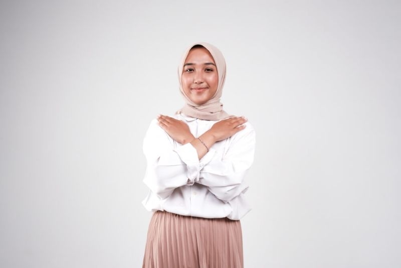 Butterfly hug. A psychology technique for self-soothing from anxiety and anger. A woman cross her arms and tap shoulder