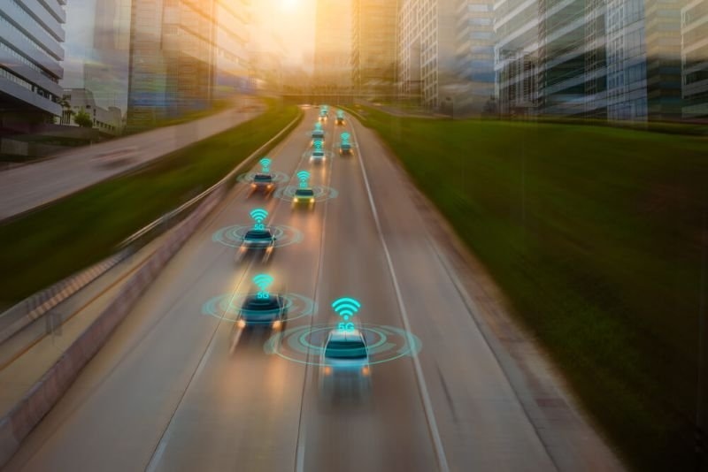 cars on a freeway running with Wi-Fi icons on top of cars 