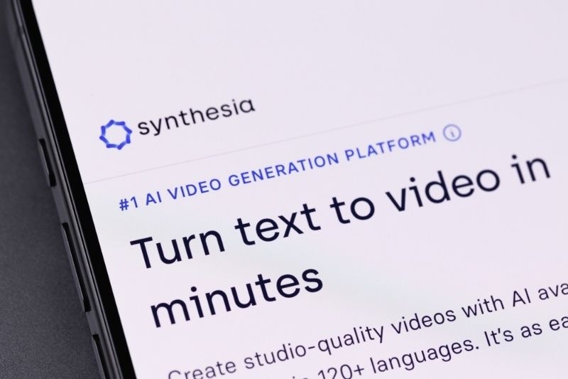 Close-up of the Synthesia AI video platform website displayed on a smartphone screen.