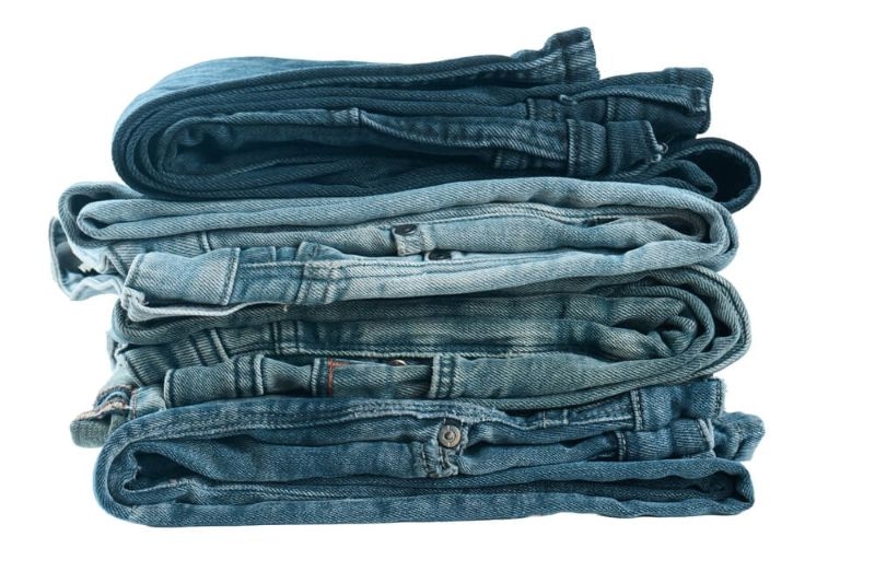 Denim jeans stacked neatly in varied shades of blue